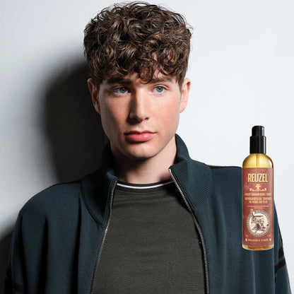 Man with brown hair styled with REUZEL Spray Grooming Tonic