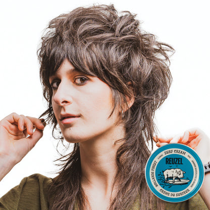 Woman with brown hair styled with REUZEL surf cream