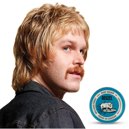 Man with blonde hair styled with REUZEL surf cream