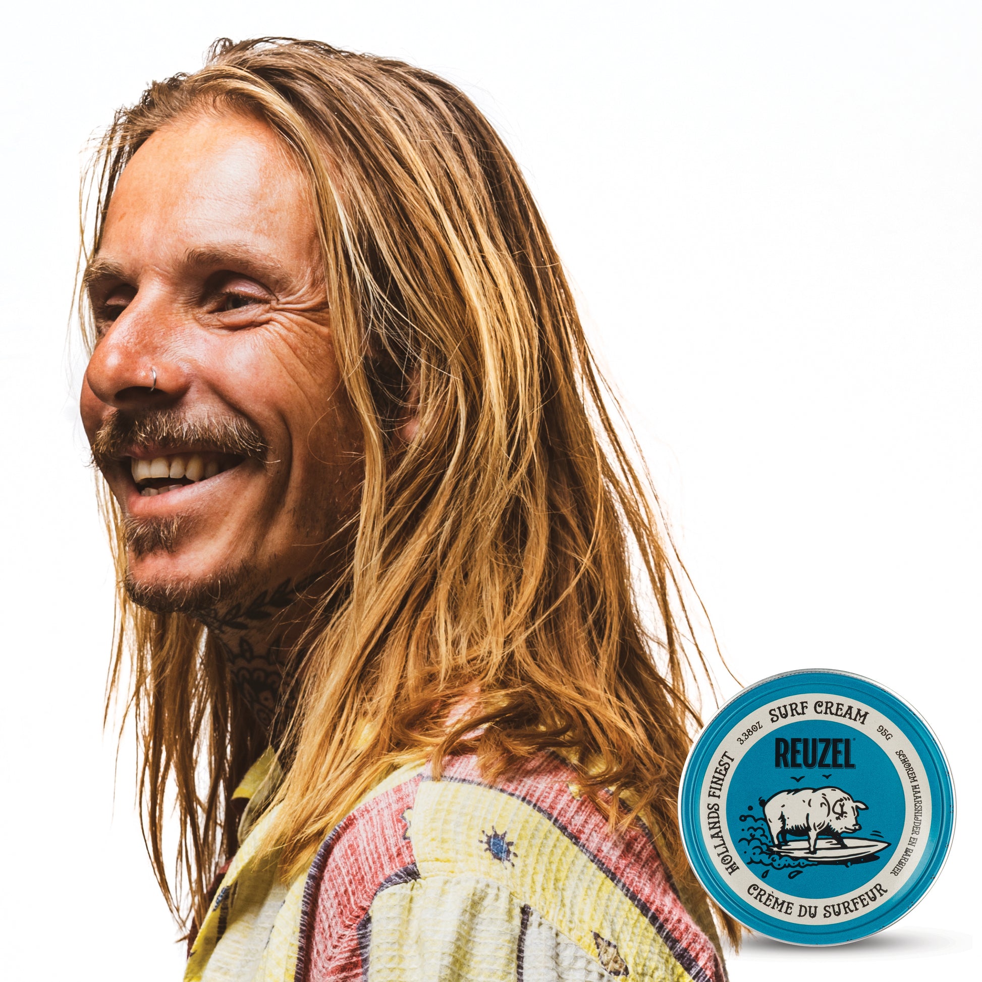 Man with brown hair styled with REUZEL surf cream