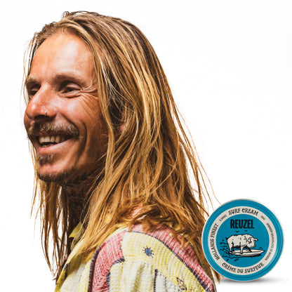 Man with brown hair styled with REUZEL surf cream