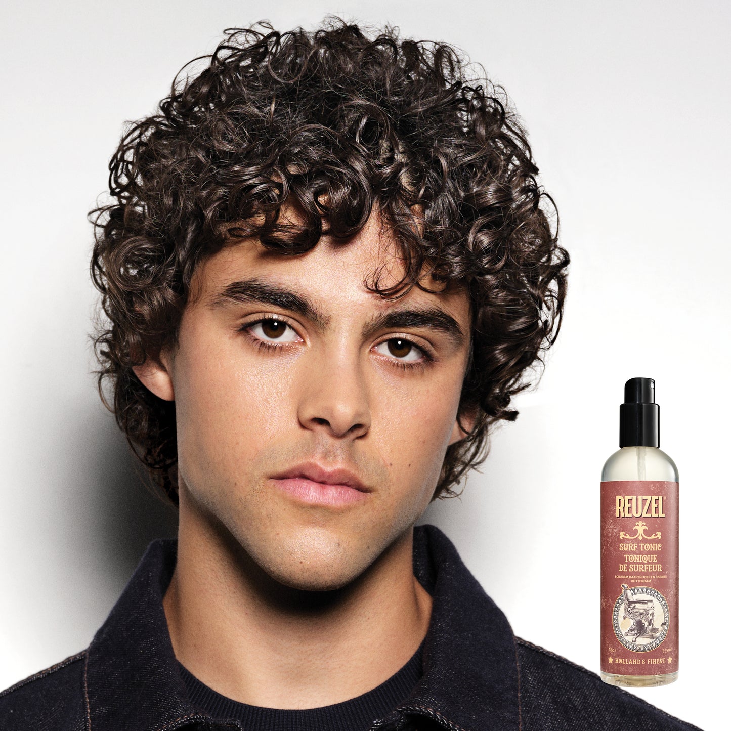 Reuzelinc Surf Tonic Salt Spray for hair, showing a clear bottle with product label, designed for textured, beachy hairstyles.