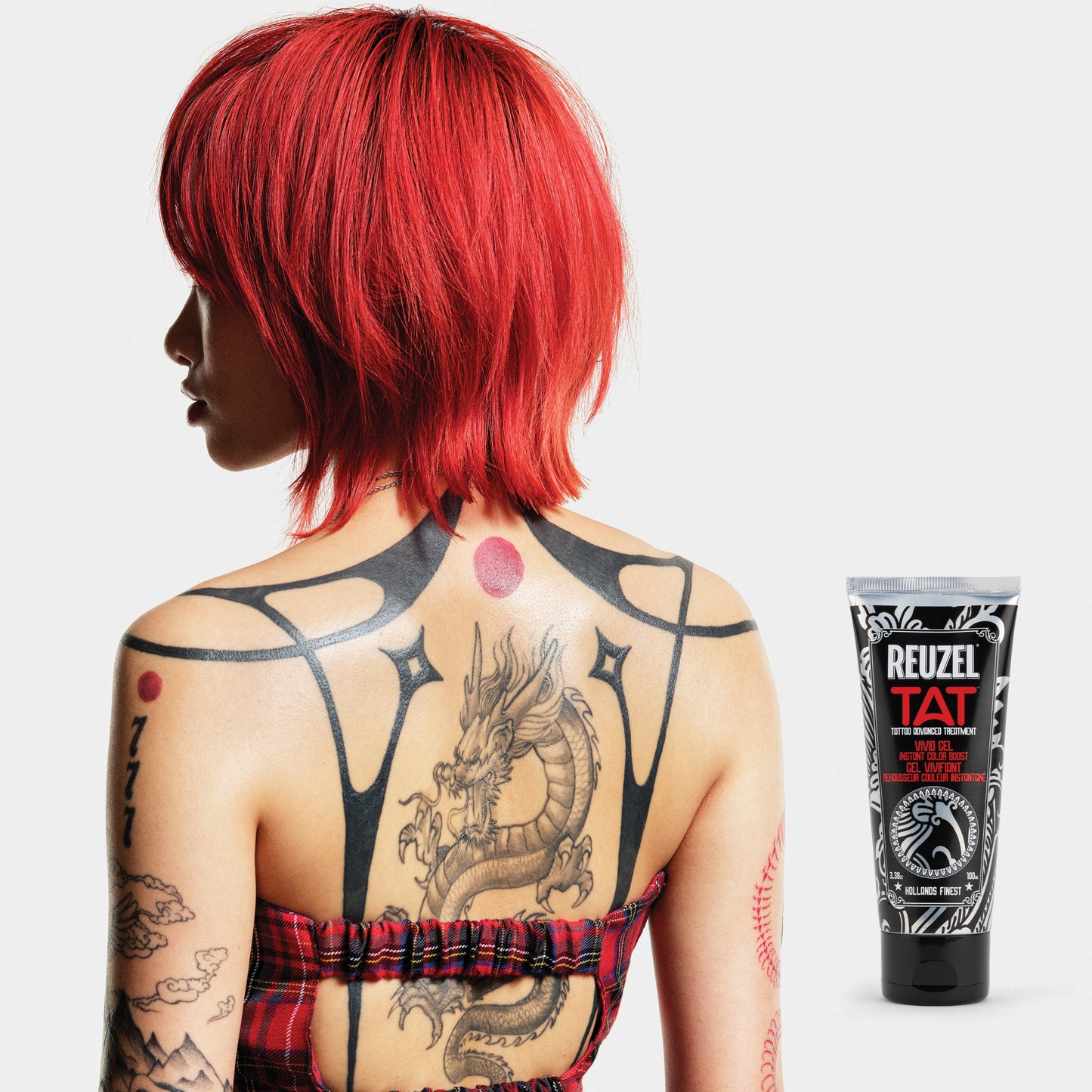 Woman with vibrant tattoos used with REUZEL TAT Vivid Gel