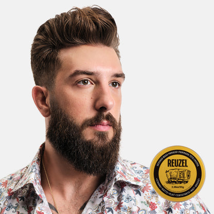Man with styled hair and a beard next to a puck of REUZEL x Liquid Death Severed Head Strong Matte Clay Pomad on a white background
