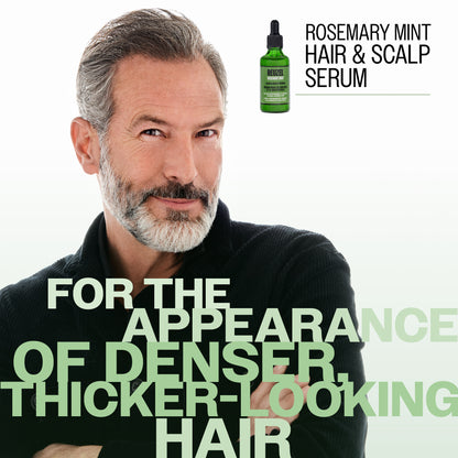 A man with gray hair and a beard is shown against a white background, with large text reading 'FOR THE APPEARANCE OF DENSER, THICKER-LOOKING HAIR.' A small green dropper bottle labeled 'REUZEL ROSEMARY MINT HAIR & SCALP SERUM' appears in the upper right.