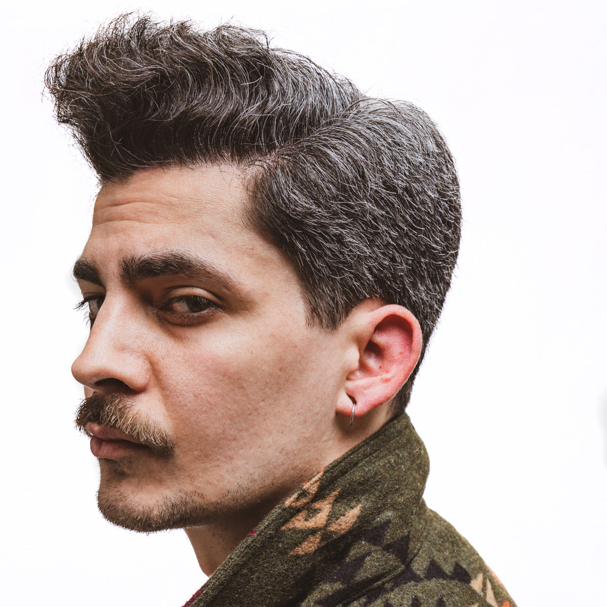 profile of man with mustache using mustache wax