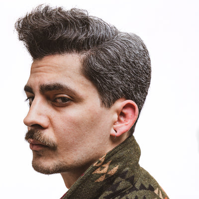 profile of man with mustache using mustache wax