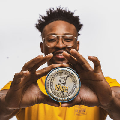 Man holding container of shave cream